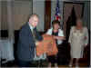 Joseph and Maria Bellomo hold the lifejacket as Maria Tenaglia looks on. Photo by Anthony Grillo