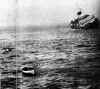 A lifeboat flees a dying ship. Photo: Loomis Dean